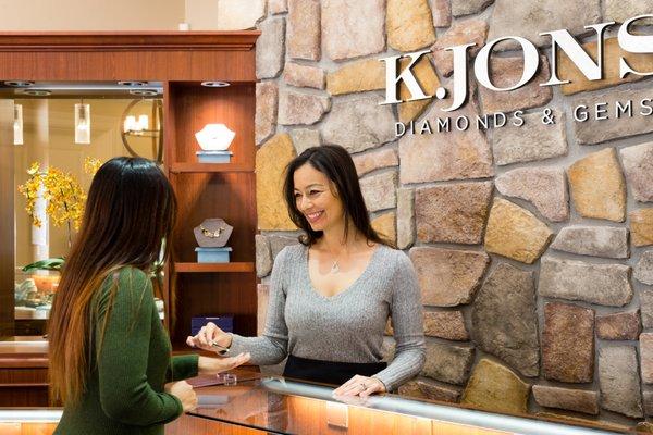 Angela helping a client looking at diamonds for an engagement ring.