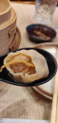 Soup dumplings with ginger garnish