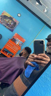 Barber and client having fun