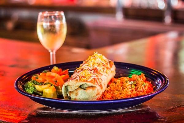 Vegetarian Burrito with a glass of chardonnay. Fresh steamed veggies and rice