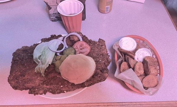 Breaded Pork Tenderloin and fried potato slices.