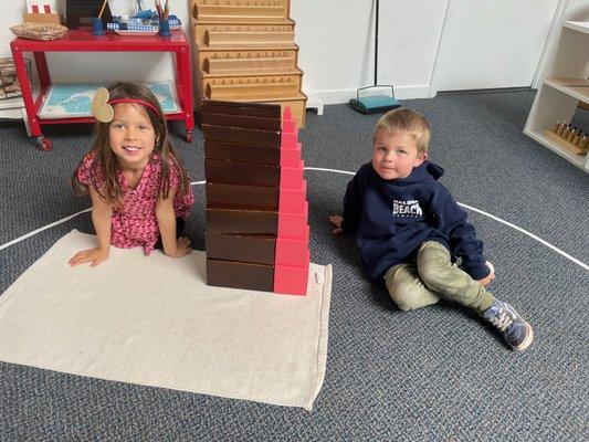 Building together with the brown stair and pink tower