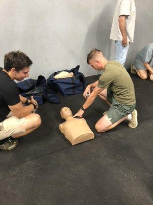 Students checking for a pulse on our manikins.