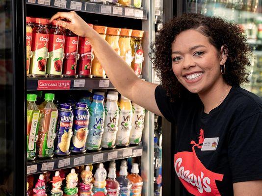 Casey's team member stocking cooler with drinks