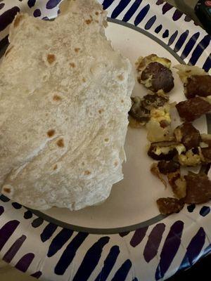 Dry tasteless breakfast burrito with hard overcooked old meat