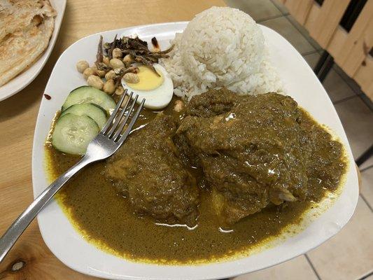 Nasi Lemak 10/10 Curry chicken with rice, egg, peanut, crispy anchovies, and sambal. The sambal was the best part.