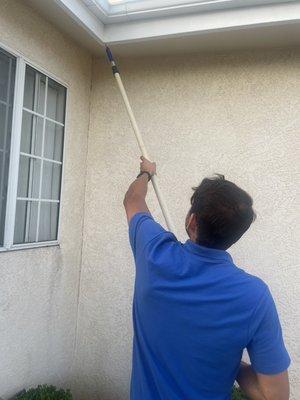 Probing the exterior for dry-rot and/or termite