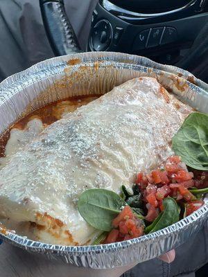 Birria Burrito, wet. The sauce is so good! The meat is so good! And it's huge! That's my thumb at the bottom of the container!