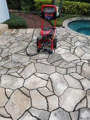 Pressure washing my clients patio around pool and fountain area