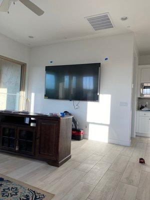 85" TV with bracket, mounted on the wall.  Blue tape was to show me what the location would look like.