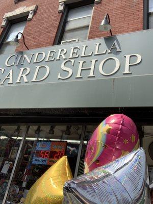 Sign for cinderella card shop and balloons that they sell