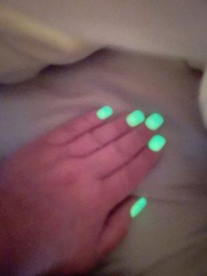 Ombré neon nails glowing after exposure to UV light