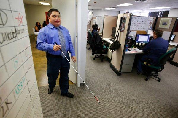 philanthropy and contact center staff with white cane