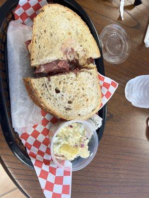 Reuben sandwich with potato salad and pickle