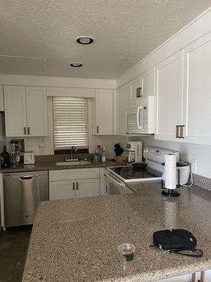 Kitchen fully stocked with dish-ware and all the convenient appliances