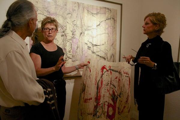 Tracey Adams talking about her unframed folded work to artists Howard Hersh and Lorraine Lawson photo credit: Marie Cameron