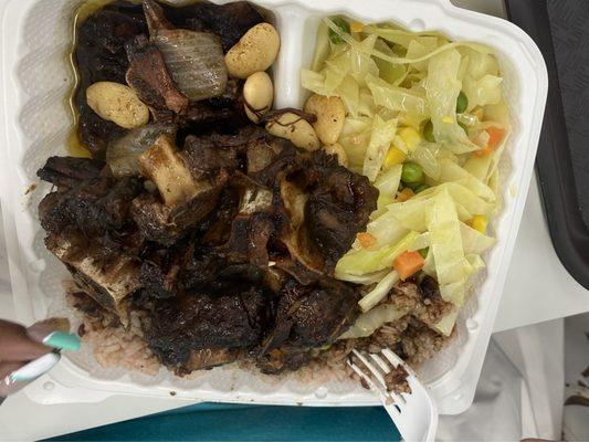 Oxtails and beans with rice and peas and Steamed Cabbage