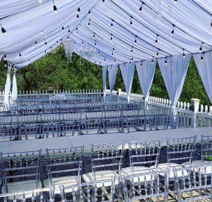 20x40 draped in white, 100 clear chiavari chairs and bistro lighting