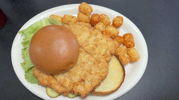 Pork tenderloin sandwich and tator tots. The menu says the tenderloin is hand breaded but it's just a fritter.