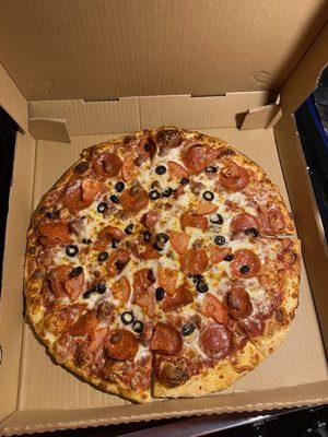 large pizza with pepperoni, black olives, tomatoes, and Italian sausage