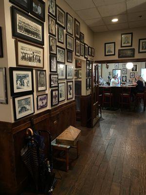 The walls decorated in framed pictures in one room