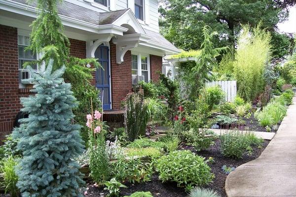 Asian themed garden with stone walls and pergola.