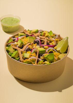 Romaine lettuce, corn, black beans, tortilla strips, red onion, shredded cheddar, avocado, with our aji verde dressing topped with a lime we