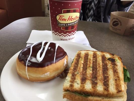 Vanilla cream-filled donut and spinach & mozzarella panini.