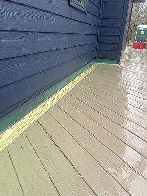 Bleached trim where painted, deck changing from brown to green.