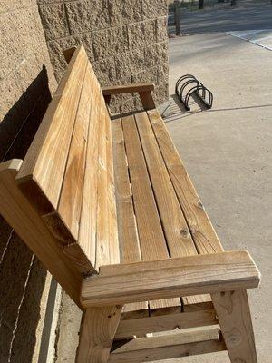 Seating and bike stand outside of the women's restroom.