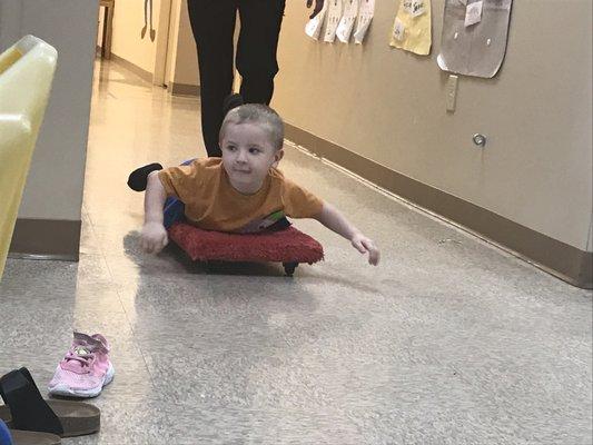 He loves the scooter board