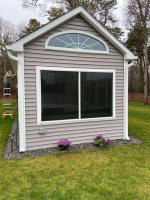 Huge slider windows and a moon installed in a summer shed