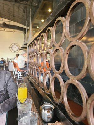 Cool mid-century modern decor, beautiful boyfriend's arm & his mimosa, with bar seating in the background