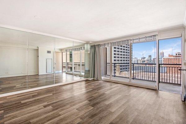 Large, bright, open living room with floor to ceiling windows.