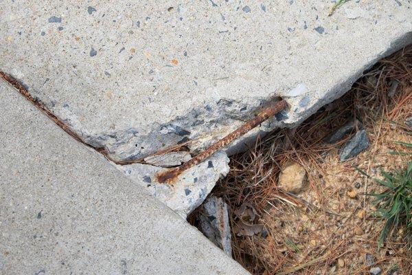 Exposed rusty sharp metal on sidewalks