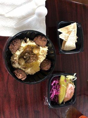 Falafel and hummus plate with side house salad is pickled cabbage.