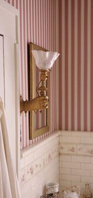 This sconce is original and represents the hand of the Statue of Liberty.