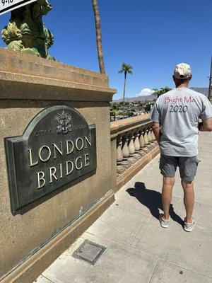 Hubby standing next to the London Bridge sign