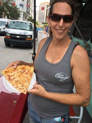 Jess showing off a slice of the Reuben Pizza