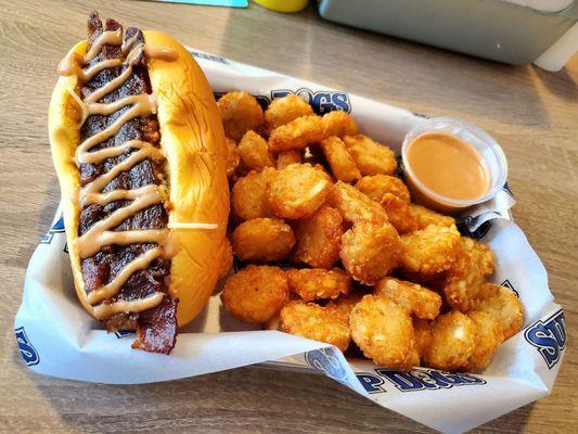 Smokehouse Dog; bacon, Monterey jack, cheddar, chili, Sup Dog sauce. Side of tots and Sup Dog sauce