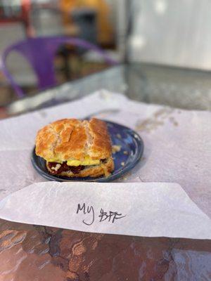 Biscuit with bacon egg and warm melty cheese... and coffee.  Definitely coffee.  Coffee not appearing in photo.