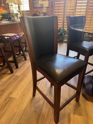 #2 Pic - Barista glass table top wood base, 5 black leather looking chairs. (Good condition B+ grade)