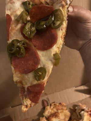 It's almost like the pepperoni and jalapeños were laid on the pizza after it was cooked