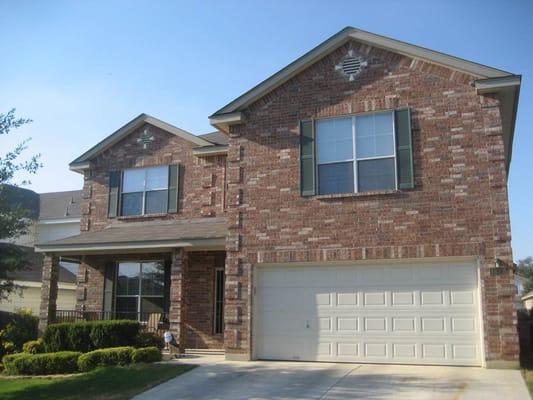 Even modern brick homes like this have plenty of wood trim, shutters, and doors that need paint to protect them from the elements.