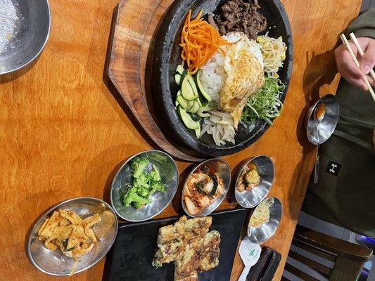 Bibimbap and sides. Half eaten seafood pancake.