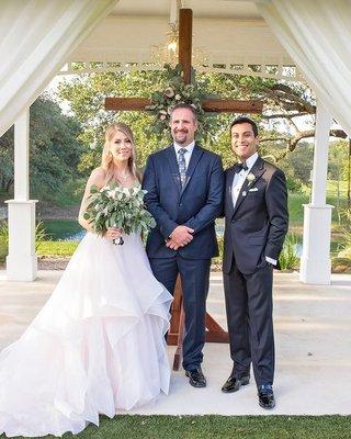 wedding officiate with bride and groom