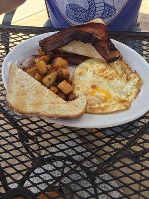 Two eggs over medium bacon and hash browns