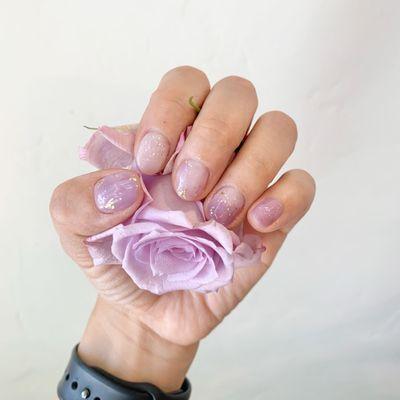 Purple and white marble nails with rainbow and gold glitter