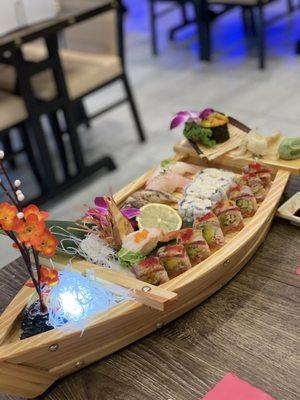 Sushi boat with amazing tuna roll, TNT roll, and assorted nigiri