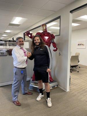 Brian Breiter and I standing next to his fully functioning Iron Man suit, which he uses to win his cases.